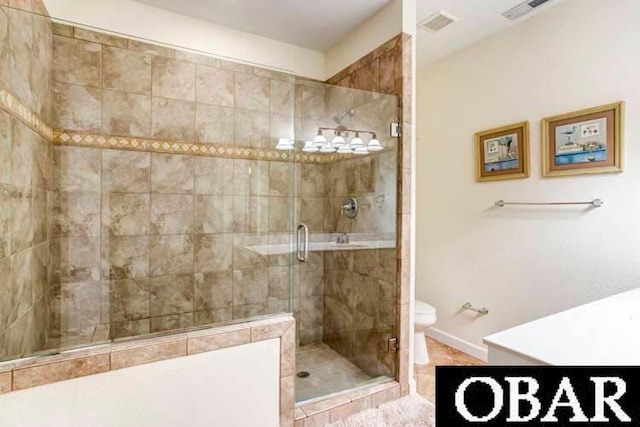 full bathroom featuring visible vents, baseboards, toilet, tile patterned floors, and a shower stall