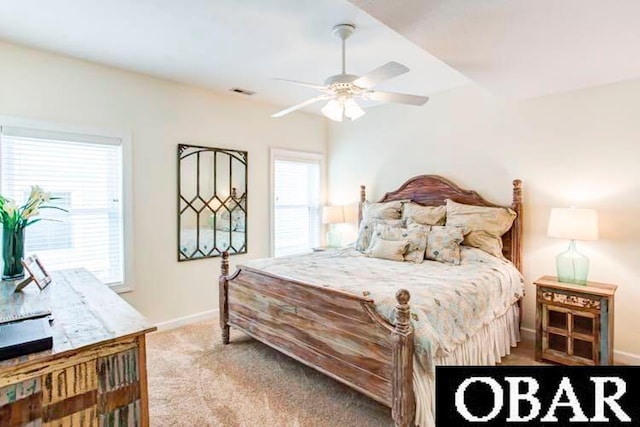 bedroom featuring carpet floors, multiple windows, visible vents, and baseboards