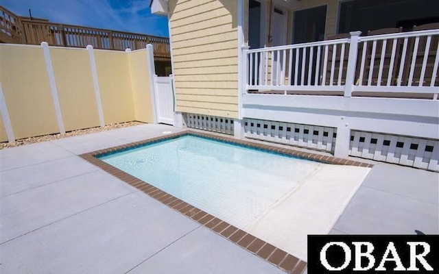 view of pool featuring fence and a patio