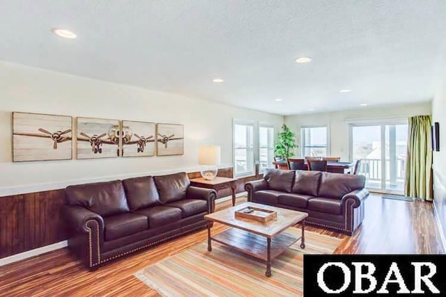 living area with recessed lighting and wood finished floors