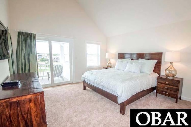 carpeted bedroom with access to exterior, baseboards, and high vaulted ceiling