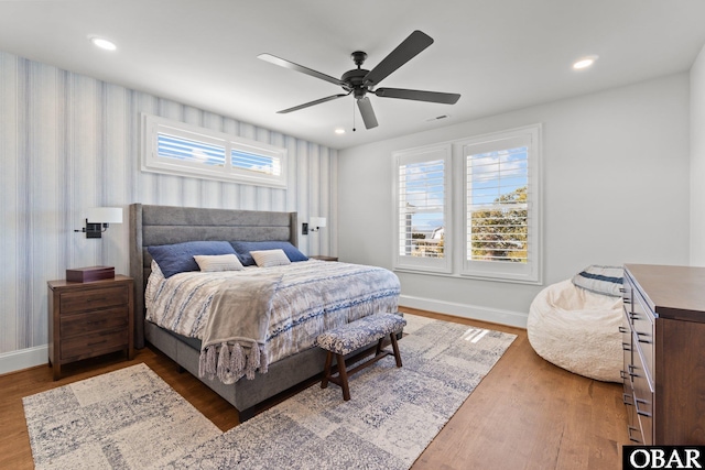 bedroom featuring ceiling fan, recessed lighting, wood finished floors, visible vents, and baseboards