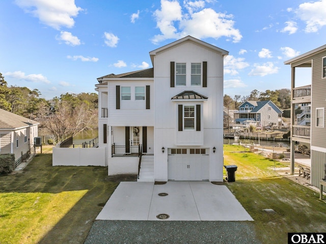 view of front facade featuring a front yard, concrete driveway, and an attached garage