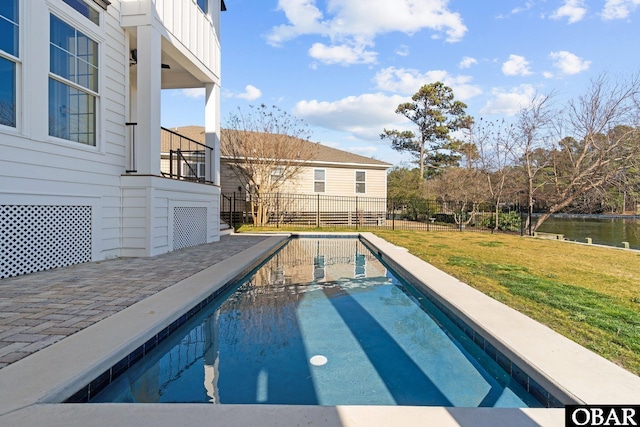 view of swimming pool with a water view, fence, a fenced in pool, and a yard