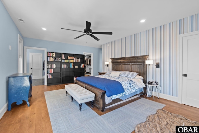 bedroom with recessed lighting, ceiling fan, wood finished floors, baseboards, and wallpapered walls