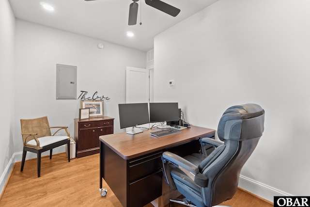 office with baseboards, electric panel, ceiling fan, and light wood finished floors