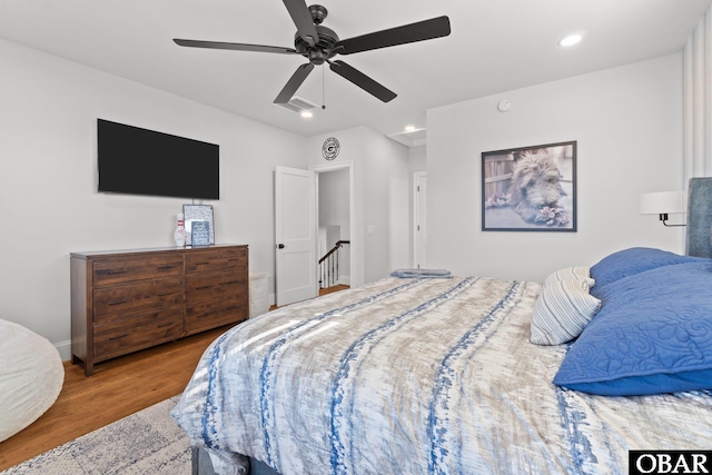 bedroom with baseboards, a ceiling fan, wood finished floors, and recessed lighting