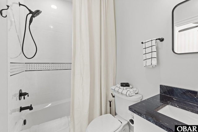 bathroom featuring vanity, toilet, and shower / bath combo with shower curtain