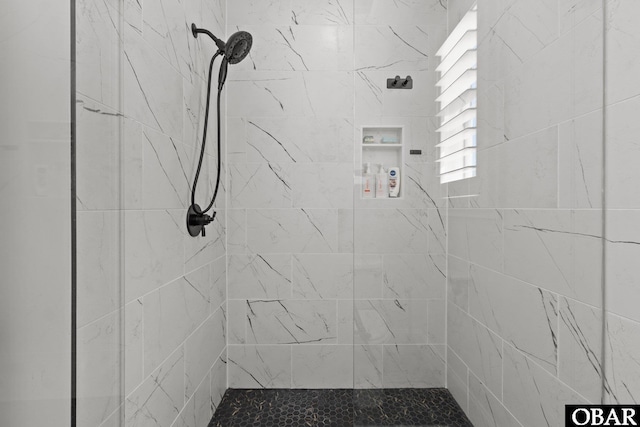 bathroom with a tile shower