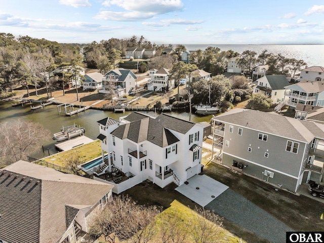 drone / aerial view with a residential view and a water view