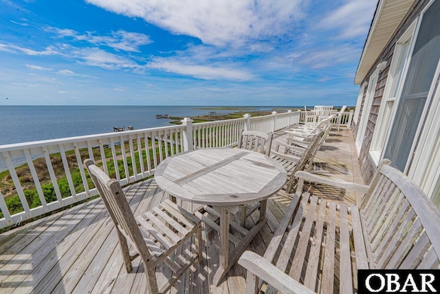 wooden terrace featuring a water view