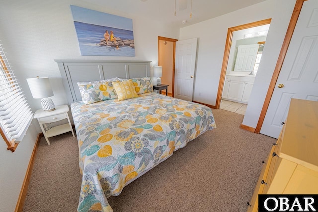 carpeted bedroom with baseboards and connected bathroom