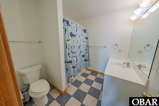 bathroom featuring toilet, vanity, curtained shower, and tile patterned floors