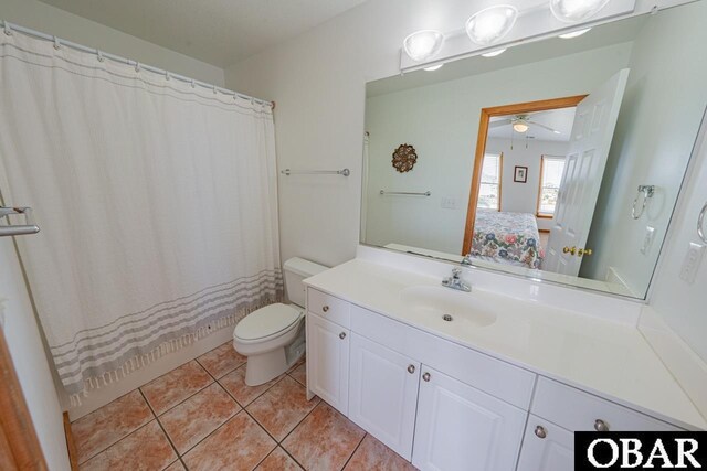 ensuite bathroom with tile patterned floors, toilet, ensuite bathroom, vanity, and a ceiling fan