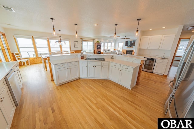 kitchen featuring visible vents, light wood-style flooring, and plenty of natural light