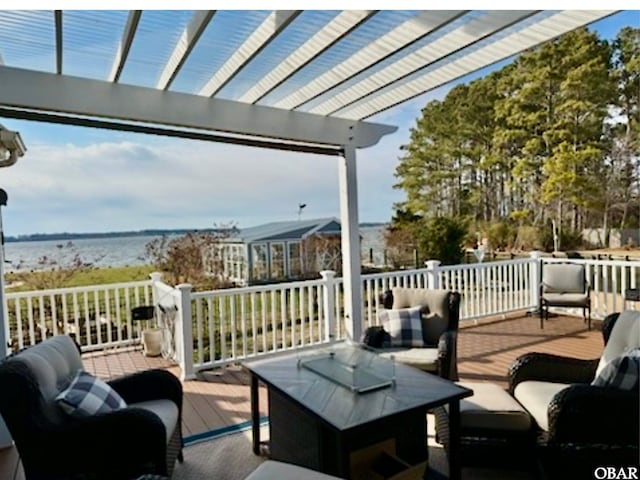 wooden terrace with a water view, an outdoor living space, and a pergola