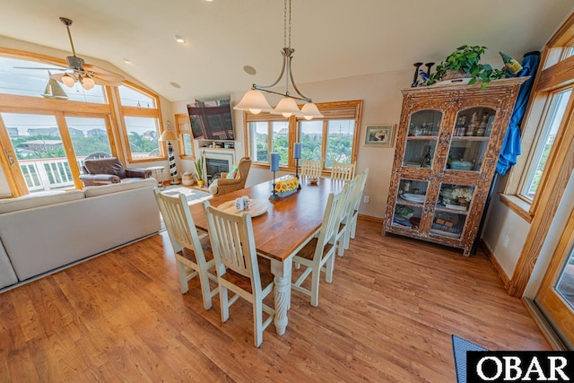 39972 NC-12 Hwy Lot 15, Avon, NC 27915 - dining area with light wood-type flooring, a glass covered fireplace, baseboards, ceiling fan, and vaulted ceiling