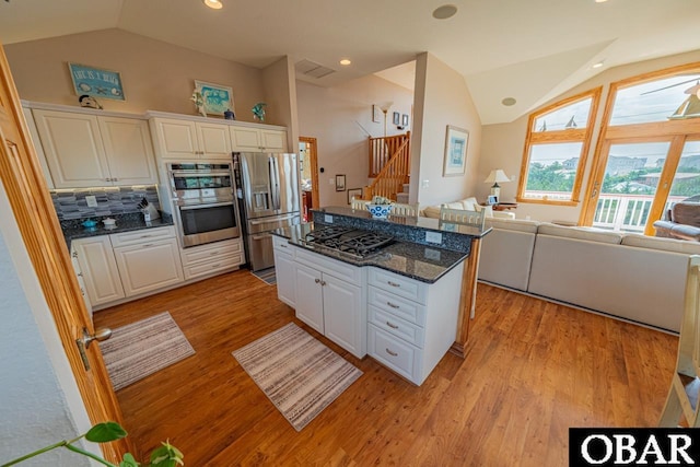 39972 NC-12 Hwy Lot 15, Avon, NC 27915 - kitchen featuring vaulted ceiling, white cabinets, open floor plan, and stainless steel appliances