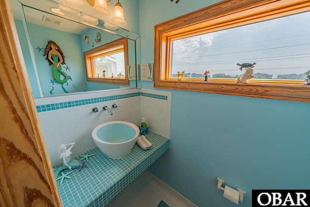 39972 NC-12 Hwy Lot 15, Avon, NC 27915 - bathroom with tile patterned floors, visible vents, tile walls, and a wainscoted wall