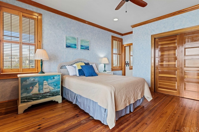 bedroom featuring ceiling fan, ornamental molding, and dark wood-style flooring