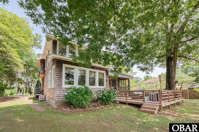 116 Swan View Dr Lot 5, Kill Devil Hills, NC 27948 - view of front of house featuring a wooden deck, a front lawn, and a sunroom