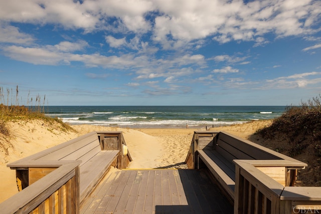 view of property's community featuring a water view and a view of the beach