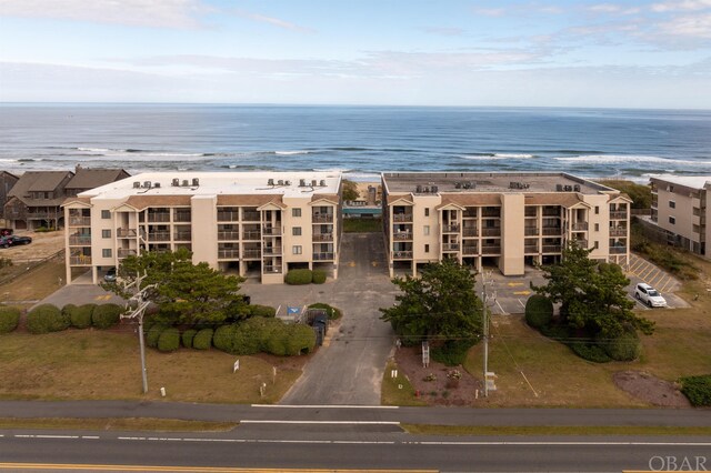 birds eye view of property with a water view and a view of the beach