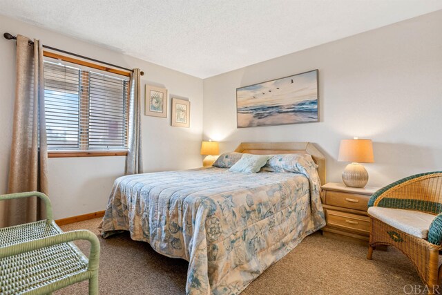 bedroom with light carpet, a textured ceiling, and baseboards