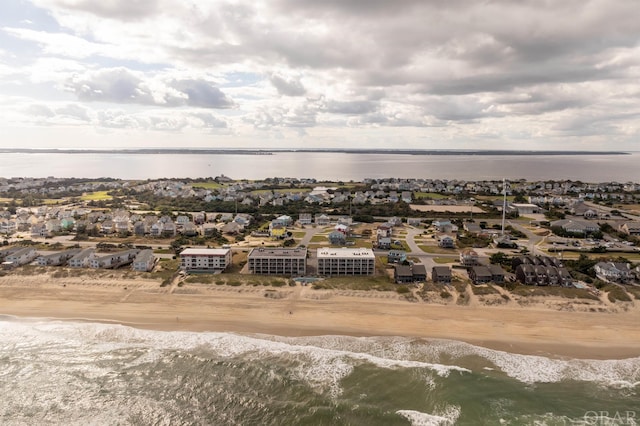 bird's eye view with a water view and a beach view