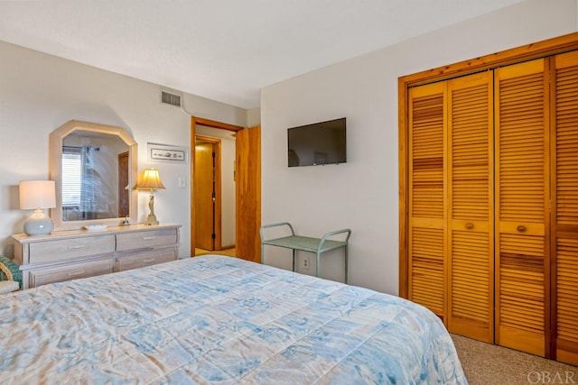 carpeted bedroom featuring a closet and visible vents