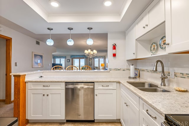 kitchen featuring a peninsula, appliances with stainless steel finishes, a tray ceiling, and white cabinets