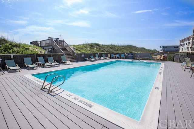 community pool with fence and stairway