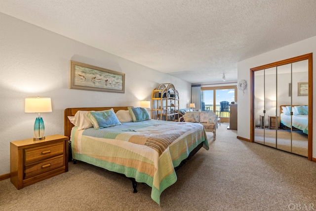 bedroom with a textured ceiling, light carpet, baseboards, access to outside, and a closet