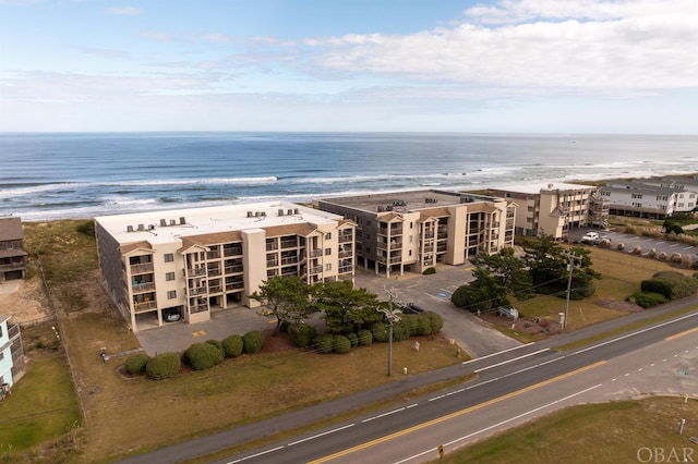 bird's eye view with a water view and a beach view