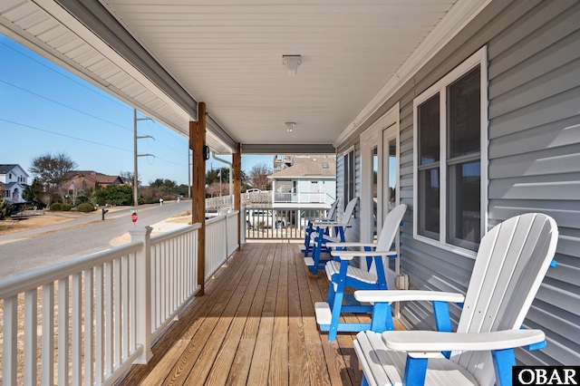 deck with covered porch and a residential view