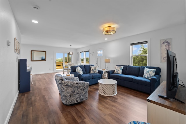 living area with a healthy amount of sunlight, baseboards, dark wood-style flooring, and recessed lighting