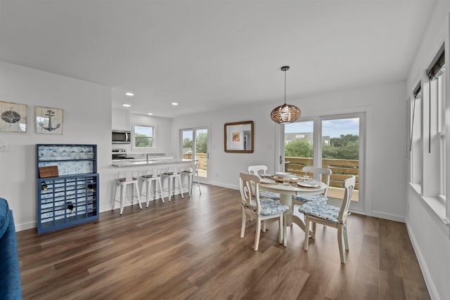 dining space featuring plenty of natural light, dark wood finished floors, baseboards, and recessed lighting