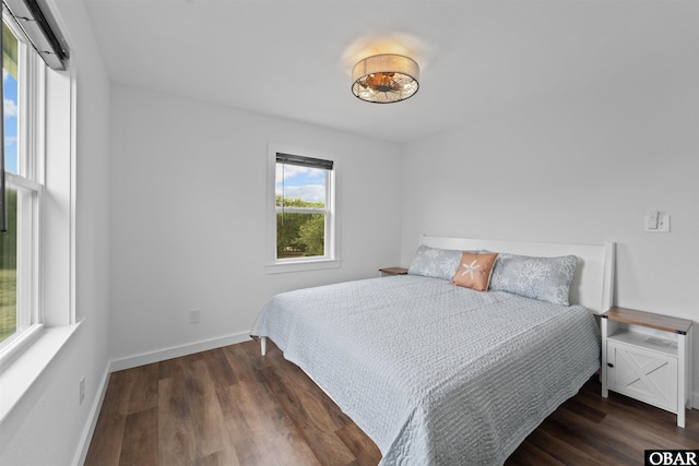 bedroom featuring baseboards and wood finished floors