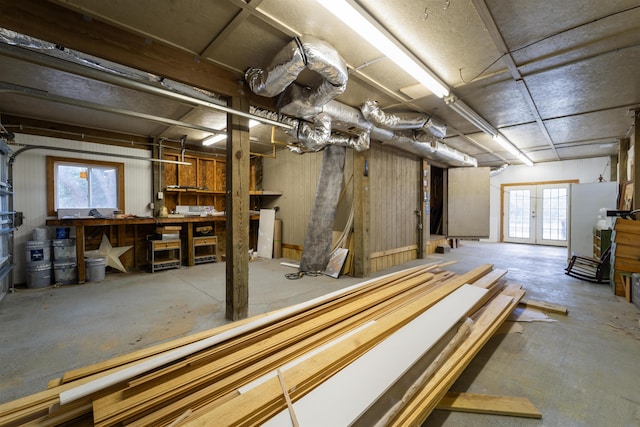 basement featuring french doors and a workshop area