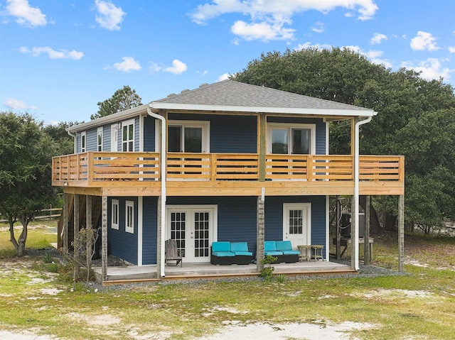 back of house featuring french doors, roof with shingles, a patio area, a deck, and an outdoor living space