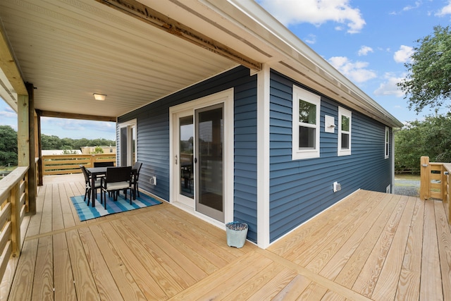 wooden deck featuring outdoor dining space