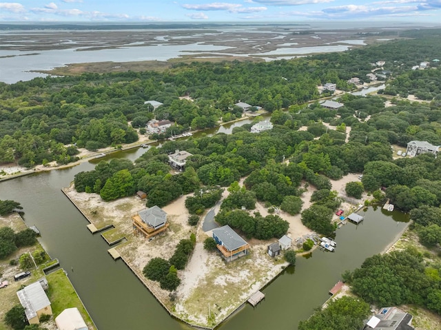 aerial view featuring a water view and a forest view