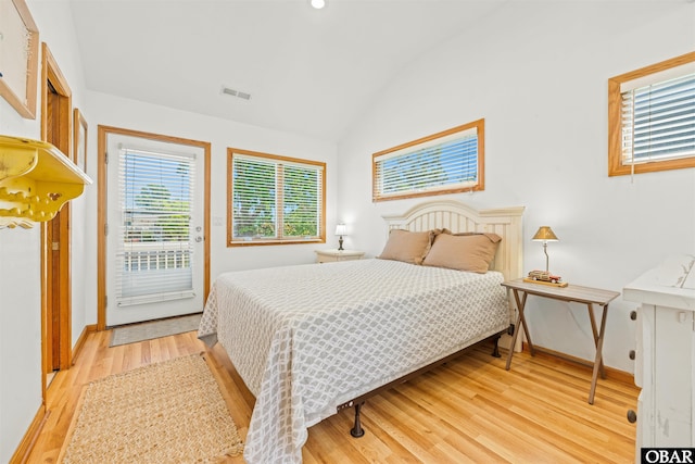 4005 Ivy Ln Lot # 16, Kitty Hawk, NC 27949 - bedroom featuring vaulted ceiling, multiple windows, light wood-style flooring, access to exterior, and baseboards