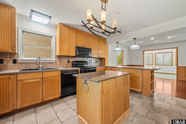 4005 Ivy Ln Lot # 16, Kitty Hawk, NC 27949 - kitchen featuring black appliances, a sink, a peninsula, a kitchen island, and a chandelier