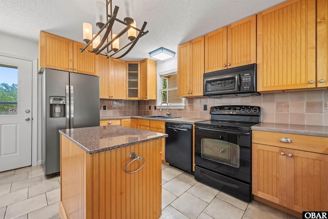 4005 Ivy Ln Lot # 16, Kitty Hawk, NC 27949 - kitchen with black appliances, a sink, a center island, a textured ceiling, and light tile patterned floors
