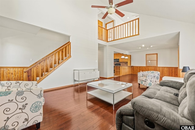 4005 Ivy Ln Lot # 16, Kitty Hawk, NC 27949 - living area with ceiling fan, stairs, a towering ceiling, hardwood / wood-style floors, and wooden walls