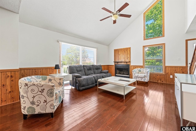 4005 Ivy Ln Lot # 16, Kitty Hawk, NC 27949 - living room with wainscoting, wood walls, a ceiling fan, dark wood finished floors, and high vaulted ceiling
