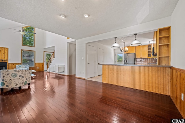 4005 Ivy Ln Lot # 16, Kitty Hawk, NC 27949 - unfurnished living room with a wainscoted wall, a ceiling fan, a textured ceiling, hardwood / wood-style floors, and wood walls