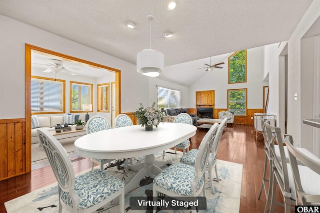 4005 Ivy Ln Lot # 16, Kitty Hawk, NC 27949 - dining space featuring a ceiling fan, wainscoting, wood-type flooring, a textured ceiling, and wood walls