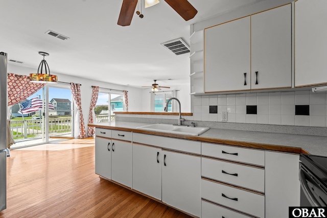 1612 Harbour View Dr Lot 114, Kill Devil Hills, NC 27948 - kitchen featuring a ceiling fan, a sink, white cabinetry, and decorative backsplash